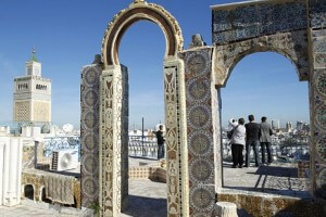 Tourists take pictures as they tour the medina, the old city of Tunis